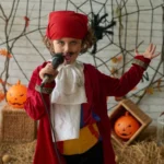 young boy in pirate costume with microphone