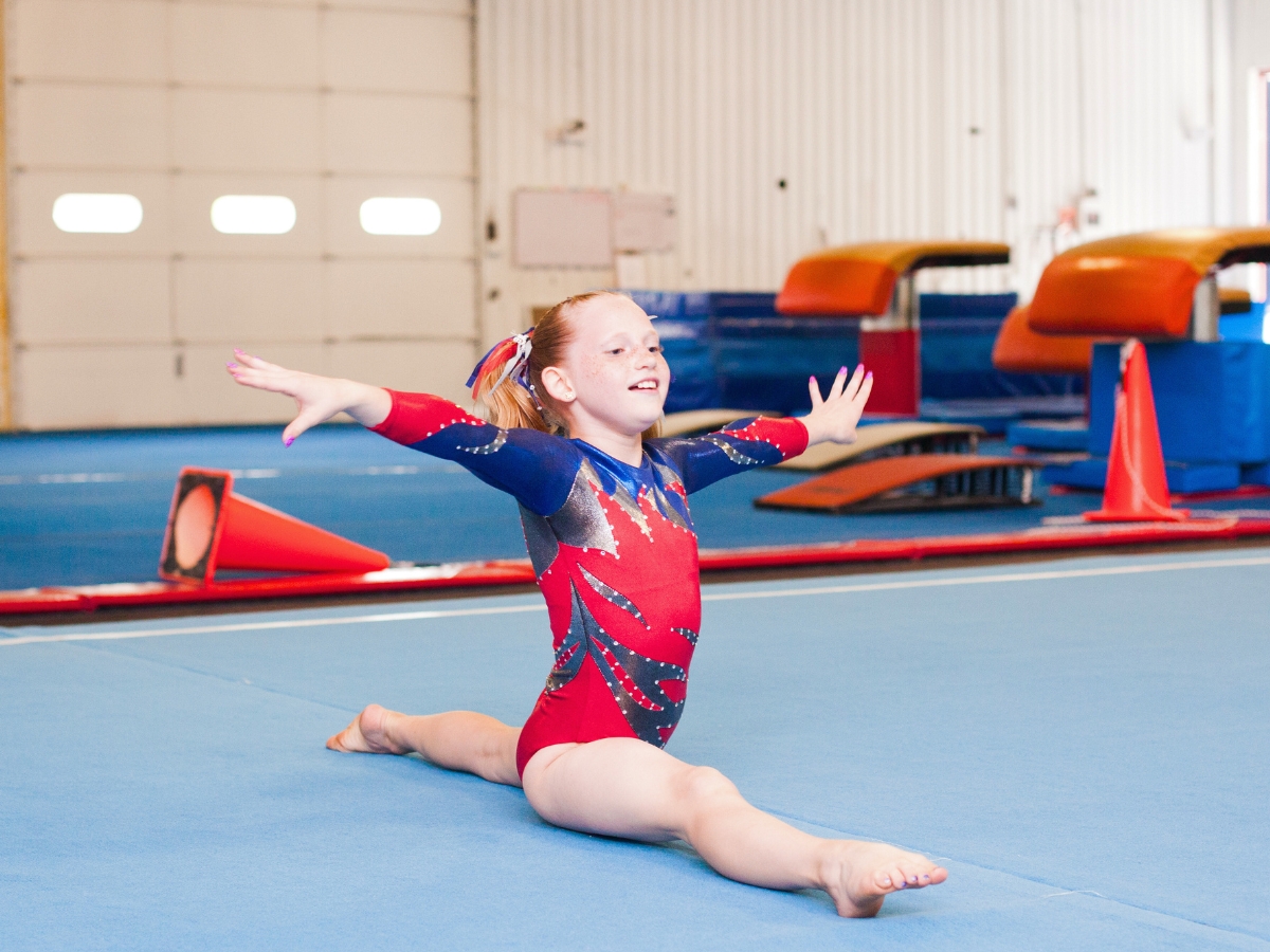 Gymnast performs the spilts during a competition